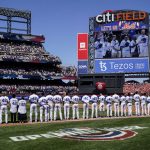 
              The New York Mets wear the number 42 in honor of Jackie Robinson as the national anthem is played before a baseball game against the Arizona Diamondbacks, Friday, April 15, 2022, in New York. (AP Photo/John Minchillo)
            