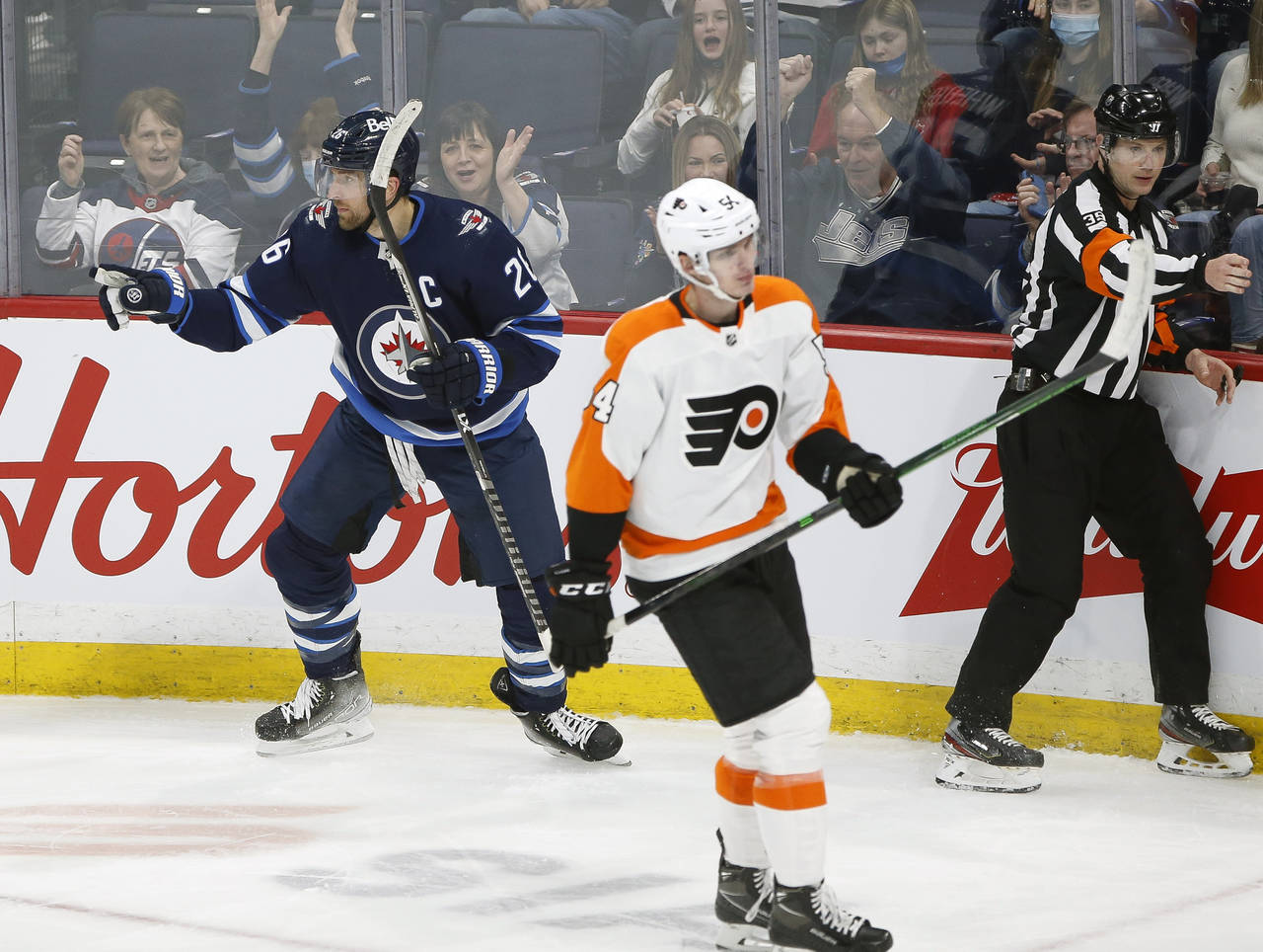 Winnipeg Jets' Blake Wheeler (26) celebrates his goal as Philadelphia Flyers' Egor Zamula (54) skat...