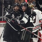 
              Los Angeles Kings center Phillip Danault (24) is hugged by teammates after scoring against the Chicago Blackhawks during the first period of an NHL hockey game Thursday, April 21, 2022, in Los Angeles. (AP Photo/Marcio Jose Sanchez)
            