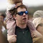 
              Driver Brad Keselowski sings along with Chris Tomlin as he holds his daughter Autumn during an Easter service before a NASCAR Cup Series auto race, Sunday, April 17, 2022, in Bristol, Tenn. (AP Photo/Wade Payne)
            