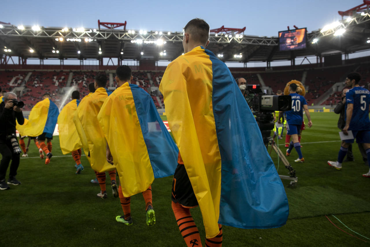 Players of Shakhtar Donetsk enter the pitch ahead of a friendly charity soccer match against Olympi...