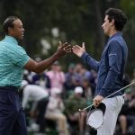 
              Tiger Woods, left, shakes hands with Joaquin Niemann, of Chile, on the 18th green during the second round at the Masters golf tournament on Friday, April 8, 2022, in Augusta, Ga. (AP Photo/Robert F. Bukaty)
            