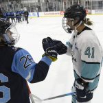 
              Team Sonnet forward Brittany Howard (41) fist-bumps Team Bauer defender Cat Quirion (26) after a hockey game as part of the Secret Dream Gap Tour, Friday, March 4, 2022, in Arlington, Va. The growth of girls and women's hockey in the Washington area is still a work in progress almost two decades into a boom of youth participation in the sport credited to Alex Ovechkin and the NHL's Capitals. (AP Photo/Nick Wass)
            