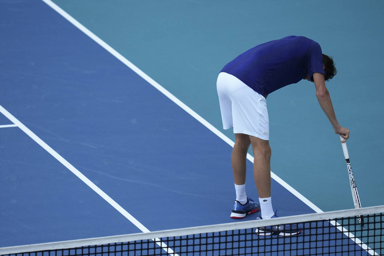 Daniil Medvedev of Russia leans over to rest between points, in his men's quarterfinal match agains...