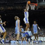
              Duke's Paolo Banchero (5) dunks in front of North Carolina's Brady Manek (45) and Leaky Black (1) during the first half of a college basketball game in the semifinal round of the Men's Final Four NCAA tournament, Saturday, April 2, 2022, in New Orleans. (AP Photo/David J. Phillip)
            