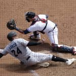 
              Miami Marlins' Avisail Garcia (24) scores as Atlanta Braves catcher Manny Pina (9) waits for the ball in the fifth inning of a baseball game Sunday, April 24, 2022, in Atlanta. Garcia scored on a single by Marlins' Garrett Cooper. (AP Photo/Ben Margot)
            