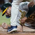 
              Oakland Athletics' Seth Brown (15) scores as the ball skips away from Tampa Bay Rays catcher Mike Zunino (10) and relief pitcher Jason Adam on a single by Stephen Piscotty during the sixth inning of a baseball game Tuesday, April 12, 2022, in St. Petersburg, Fla. (AP Photo/Chris O'Meara)
            