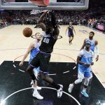 
              Sacramento Kings center Neemias Queta (88) dunks against the Los Angeles Clippers during the first half of an NBA basketball game Saturday, April 9, 2022, in Los Angeles. (AP Photo/Marcio Jose Sanchez)
            
