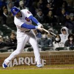 
              Chicago Cubs' Ian Happ hits an RBI single off Tampa Bay Rays relief pitcher Jeffrey Springs during the seventh inning of a baseball game Monday, April 18, 2022, in Chicago. Seiya Suzuki scored on the play. (AP Photo/Charles Rex Arbogast)
            