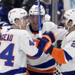 
              New York Islanders right wing Josh Bailey (12) celebrates his goal with teammates Jean-Gabriel Pageau (44) and Kyle Palmieri (21) during the second period of an NHL hockey game, in Toronto, Sunday, April 17, 2022. (Frank Gunn/The Canadian Press via AP)
            