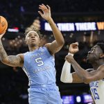 
              North Carolina's Armando Bacot (5) shoots over Duke's Mark Williams (15) during the first half of a college basketball game in the semifinal round of the Men's Final Four NCAA tournament, Saturday, April 2, 2022, in New Orleans. (AP Photo/David J. Phillip)
            