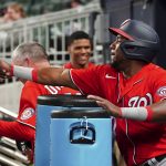 
              Washington Nationals' Maikel Franco celebrates in the dugout after hitting a three-run double in the eighth inning of a baseball game against the Atlanta Braves Monday, April 11, 2022, in Atlanta. (AP Photo/John Bazemore)
            
