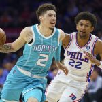 
              Charlotte Hornets' LaMelo Ball, left, drives to the basket against Philadelphia 76ers' Matisse Thybulle, right, during the first half of an NBA basketball game, Saturday, April 2, 2022, in Philadelphia. (AP Photo/Chris Szagola)
            