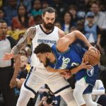 
              Minnesota Timberwolves center Karl-Anthony Towns handles the ball against Memphis Grizzlies center Steven Adams during the first half of Game 1 of a first-round NBA basketball playoff series Saturday, April 16, 2022, in Memphis, Tenn. (AP Photo/Brandon Dill)
            