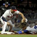 
              Atlanta Braves first baseman Matt Olson tags out Chicago Cubs' Michael Hermosillo at first base for a double play during the eighth inning of a baseball game at Truist Park Tuesday, April 26, 2022, in Atlanta. (Jason Getz/Atlanta Journal-Constitution via AP)
            