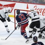 
              Los Angeles Kings Alexander Edler (2) can't stop the shot from Winnipeg Jets' Adam Lowry (17) from crossing the line for a goal during the second period of an NHL hockey game Saturday, April 2, 2022, in Winnipeg, Manitoba. (John Woods/The Canadian Press via AP)
            