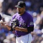 
              Colorado Rockies starting pitcher Antonio Senzatela hands the ball to manager Bud Black as he pulls Senzatela from the mound after he gave up a single to Los Angeles Dodgers' Gavin Lux in the fourth inning of a baseball game Sunday, April 10, 2022, in Denver. (AP Photo/David Zalubowski)
            