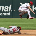 
              Texas Rangers shortstop Charlie Culberson (11) leaps over Los Angeles Angels' Brandon Marsh (16) who steals second in the fifth inning during a baseball game on Sunday, April 17, 2022, in Arlington, Texas. (AP Photo/Richard W. Rodriguez)
            