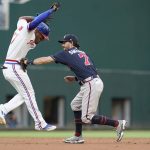 
              Atlanta Braves shortstop Dansby Swanson (7) tags out Texas Rangers' Andy Ibanez at second base during the second inning of a baseball game in Arlington, Texas, Saturday, April 30, 2022. Zach Reks was safe at first. (AP Photo/LM Otero)
            
