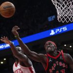 
              Toronto Raptors' Pascal Siakam, right, gets the offensive rebound against Houston Rockets' Usman Garuba during the first half of an NBA basketball game in Toronto on Friday, April 8, 2022. (Chris Young/The Canadian Press via AP)
            