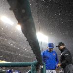 
              New York Mets manager Buck Showalter, left, and umpire Mark Carlson talk as a rain delay is declared during the ninth inning of a baseball game against the Washington Nationals at Nationals Park, Friday, April 8, 2022, in Washington. (AP Photo/Alex Brandon)
            