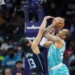 
              Orlando Magic guard R.J. Hampton, left, goes up against the shot of Charlotte Hornets forward P.J. Washington, right, during the first half of an NBA basketball game on Thursday, April 7, 2022, in Charlotte, N.C. (AP Photo/Rusty Jones)
            