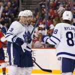 
              Toronto Maple Leafs defenseman Justin Holl (3) celebrates with right wing William Nylander (88) after Holl scored during the first period of the team's NHL hockey game against the Florida Panthers, Saturday, April 23, 2022, in Sunrise, Fla. (AP Photo/Lynne Sladky)
            