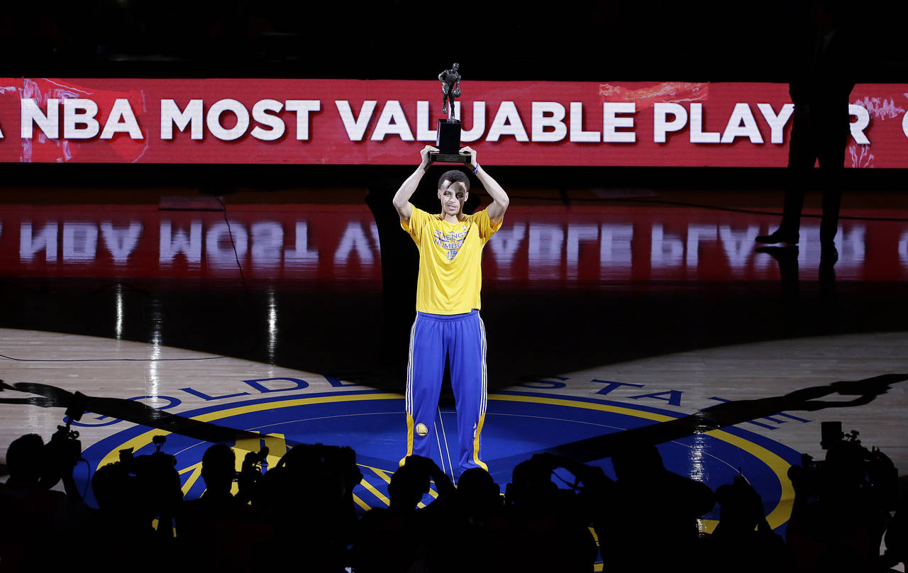 FILE - Golden State Warriors guard Stephen Curry acknowledges the crowd during a ceremony for winni...