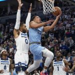 
              Memphis Grizzlies forward Desmond Bane, right, goes up for a shot past Minnesota Timberwolves guard D'Angelo Russell during the first half in Game 4 of an NBA basketball first-round playoff series Saturday, April 23, 2022, in Minneapolis. (AP Photo/Craig Lassig)
            