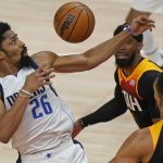 
              Dallas Mavericks guard Spencer Dinwiddie (26) tries to get a rebound next to Utah Jazz guard Mike Conley, rear, during the first half of Game 3 of an NBA basketball first-round playoff series Thursday, April 21, 2022, in Salt Lake City. (AP Photo/Rick Bowmer)
            