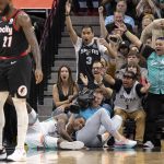 
              San Antonio Spurs guard Lonnie Walker IV (1) falls to the floor after dunking during the first half of an NBA basketball game against the Portland Trail Blazers, Friday, April 1, 2022, in San Antonio. (AP Photo/Nick Wagner)
            