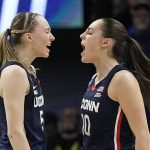 
              UConn's Nika Muhl is congratulated by Paige Bueckers after a score during the first half of a college basketball game in the semifinal round of the Women's Final Four NCAA tournament Friday, April 1, 2022, in Minneapolis. (AP Photo/Eric Gay)
            