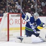 
              Vancouver Canucks goalie Thatcher Demko makes a blocker save during the second period of an NHL hockey game in Vancouver, British Columbia, Sunday, April 3, 2022. (Darryl Dyck/The Canadian Press via AP)
            