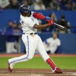 
              Toronto Blue Jays' Vladimir Guerrero Jr. (27) connects for a solo home run against the Texas Rangers during a baseball game in Toronto, Sunday, April 10, 2022. (Frank Gunn/The Canadian Press via AP)
            