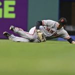 
              San Francisco Giants right fielder Mike Yastrzemski slides after catching a ball hit by Cleveland Guardians' Josh Naylor in the fourth inning of a baseball game, Saturday, April 16, 2022, in Cleveland. (AP Photo/David Dermer)
            