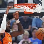 
              Phoenix Suns center Deandre Ayton dunks during the first half of the team's NBA basketball game against the Utah Jazz on Friday, April 8, 2022, in Salt Lake City. (AP Photo/Rick Bowmer)
            