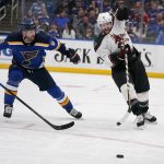 
              Arizona Coyotes' Phil Kessel (81) and St. Louis Blues' Marco Scandella (6) chase after a loose puck during the third period of an NHL hockey game Monday, April 4, 2022, in St. Louis. (AP Photo/Jeff Roberson)
            