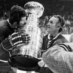
              FILE - Montreal Canadien Guy Lafleur kisses the Stanley Cup while Montreal captain Henri Richard holds the cup Thursday night, May 10, 1973, in Chicago. Montreal beat Chicago 6-4 and won the National Hockey League playoff. Hockey Hall of Famer Guy Lafleur, who helped the Montreal Canadiens win five Stanley Cup titles in the 1970s, died Friday, April 22, 2022, at age 70. (AP Photo/File)
            