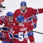 
              Montreal Canadiens' Brendan Gallagher, left, and Chris Wideman, top, congratulate Jordan Harris for his gola against the Florida Panthers during the first period of an NHL hockey game Friday, April 29, 2022, in Montreal. (Paul Chiasson/The Canadian Press via AP)
            