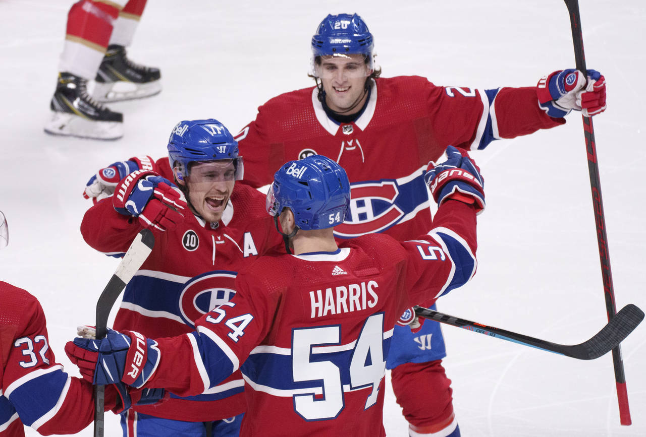 Montreal Canadiens' Brendan Gallagher, left, and Chris Wideman, top, congratulate Jordan Harris for...