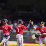 
              The Washington Nationals high-five after a win against the Atlanta Braves after a baseball game, Wednesday, April 13, 2022, in Atlanta. (AP Photo/Brynn Anderson)
            