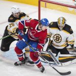
              Montreal Canadiens' Christian Dvorak (28) moves in against Boston Bruins goaltender Jeremy Swayman as Bruins' Brandon Carlo (25) defends during second-period NHL hockey game action in Montreal, Sunday, April 24, 2022. (Graham Hughes/The Canadian Press via AP)
            