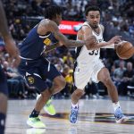 
              San Antonio Spurs guard Tre Jones, right, drives as Denver Nuggets guard Bones Hyland defends during the first half of an NBA basketball game Tuesday, April 5, 2022, in Denver. (AP Photo/David Zalubowski)
            