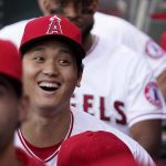 
              Los Angeles Angels' Shohei Ohtani laughs in the dugout prior to a baseball game against the Baltimore Orioles Friday, April 22, 2022, in Anaheim, Calif. (AP Photo/Mark J. Terrill)
            