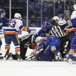
              Buffalo Sabres and New York Islanders players fight during the third period of an NHL hockey game on Saturday, April 23, 2022, in Buffalo, N.Y. (AP Photo/Joshua Bessex)
            