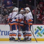 
              New York Islanders' Kyle Palmieri, center, celebrates his goal with teammates during the third period of the team's NHL hockey game against the New Jersey Devils in Newark, N.J., Sunday, April 3, 2022. The Islanders won 4-3. (AP Photo/Seth Wenig)
            