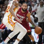 
              Miami Heat forward Caleb Martin (16) drives to the basket against Atlanta Hawks forward De'Andre Hunter (12) during the first half of Game 5 of an NBA basketball first-round playoff series, Tuesday, April 26, 2022, in Miami. (AP Photo/Wilfredo Lee)
            