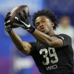 
              FILE - Ohio State wide receiver Garrett Wilson catches a pass during a drill at the NFL football scouting combine, Thursday, March 3, 2022, in Indianapolis. Wilson is a possible first round pick in the NFL Draft. (AP Photo/Charlie Neibergall, File)
            