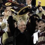 
              FILE — Boston College head coach Jerry York, center, holds up the championship trophy while celebrating their 5-0 victory over Wisconsin in the NCAA Frozen Four championship hockey game in Detroit, Saturday, April 10, 2010. York, 76, the Hockey Hall of Famer who won five NCAA championships and the most games in college hockey history, said Wednesday, April 13, 2022, that he is retiring. (AP Photo/Paul Sancya, File)
            