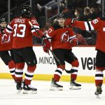 
              New Jersey Devils center Yegor Sharangovich (17) celebrates his short-handed goal with teammates during the second period of an NHL hockey game against the Florida Panthers Saturday, April 2, 2022, in Newark, N.J. The goal was his third of the game for a hat trick. (AP Photo/Bill Kostroun)
            